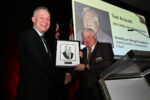 Ted Arscott accepts HOF portrait from Mark Rivett